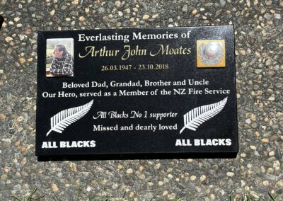 An image of a plaque headstone with intricate engravings, offering a personalized memorial tribute